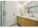 Bathroom featuring a double vanity with gold hardware, stylish mirrors, and a glass-enclosed walk-in shower at 1599 Sandtown Rd, Atlanta, GA 30311