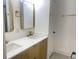 Modern bathroom featuring double sinks, gold fixtures, and a glass-enclosed shower at 1599 Sandtown Rd, Atlanta, GA 30311