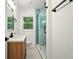Stylish bathroom with a glass shower, modern vanity, and ample natural light at 1599 Sandtown Rd, Atlanta, GA 30311
