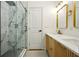 Modern bathroom featuring a double vanity with gold hardware, stylish mirrors, and a glass-enclosed walk-in shower at 1599 Sandtown Rd, Atlanta, GA 30311