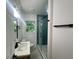 Bright bathroom features a tiled shower with glass doors, modern vanity and natural light at 1599 Sandtown Rd, Atlanta, GA 30311