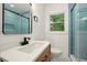 Modern bathroom with single vanity, wood-look cabinets, stylish fixtures, and a glass-enclosed shower, enhancing a spa-like feel at 1599 Sandtown Rd, Atlanta, GA 30311