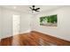 Bedroom with hardwood floors, ceiling fan, and natural light from a large window with views of the outdoors at 1599 Sandtown Rd, Atlanta, GA 30311