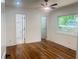 Light-filled bedroom featuring hardwood floors, freshly painted white walls, and a ceiling fan at 1599 Sandtown Rd, Atlanta, GA 30311