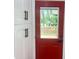 Bright red entryway door with sleek hardware on white cabinets at 1599 Sandtown Rd, Atlanta, GA 30311