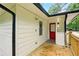 Charming home exterior features a red door, white siding, and a wooden deck at 1599 Sandtown Rd, Atlanta, GA 30311