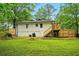 Rear view of the home featuring a backyard, deck, and staircase at 1599 Sandtown Rd, Atlanta, GA 30311