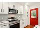 The kitchen features stainless steel appliances, white cabinets, and a stylish backsplash at 1599 Sandtown Rd, Atlanta, GA 30311