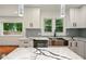 Well-lit modern kitchen with stainless steel appliances, quartz counters and island, with backyard view at 1599 Sandtown Rd, Atlanta, GA 30311