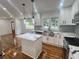 Bright kitchen with white cabinets, stainless steel appliances, granite countertops, and wood floors at 1599 Sandtown Rd, Atlanta, GA 30311