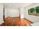 Bright, open living room with hardwood floors and a view to the kitchen with stainless appliances at 1599 Sandtown Rd, Atlanta, GA 30311