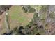 Large property showcasing a blend of open fields, wooded areas, and a well-maintained home at 689 Hardin Rd, Temple, GA 30179