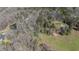 Expansive aerial view of wooded acreage with pond and single Gathering home at 689 Hardin Rd, Temple, GA 30179