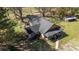 Aerial view of a charming home with a well-maintained roof and lush landscaping at 689 Hardin Rd, Temple, GA 30179