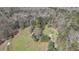 Picturesque aerial view of a property nestled among dense trees and serene surroundings at 689 Hardin Rd, Temple, GA 30179