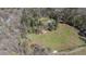 Beautiful aerial perspective of a property featuring a home, expansive land, and mature trees at 689 Hardin Rd, Temple, GA 30179