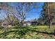 Expansive backyard with mature trees, a picnic table, and an inviting outdoor space for relaxation and recreation at 689 Hardin Rd, Temple, GA 30179