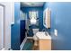 Charming blue bathroom with a shower-tub combo and a sink at 689 Hardin Rd, Temple, GA 30179