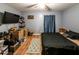 Simple bedroom features wood laminate flooring, and a bed at 689 Hardin Rd, Temple, GA 30179