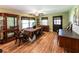 Dining room with wooden furniture, hardwood floors, and natural light from the windows at 689 Hardin Rd, Temple, GA 30179