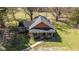 Front aerial view of charming brick home with welcoming porch and manicured lawn at 689 Hardin Rd, Temple, GA 30179