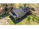Aerial side view of home featuring a brick facade and elevated wooden deck at 689 Hardin Rd, Temple, GA 30179