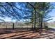 View of the surrounding land featuring fenced areas and mature trees under a blue sky at 689 Hardin Rd, Temple, GA 30179