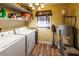 Functional laundry room with washer, dryer, shelving and storage space at 689 Hardin Rd, Temple, GA 30179