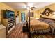 Comfortable main bedroom with wood laminate flooring, an ensuite bathroom, and a decorative bed at 689 Hardin Rd, Temple, GA 30179