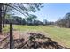 Scenic view of expansive open field, framed by lush trees, offering endless possibilities at 689 Hardin Rd, Temple, GA 30179
