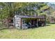 Outdoor view of a shed featuring weathered materials, open storage, and a glimpse of outdoor equipment at 689 Hardin Rd, Temple, GA 30179