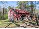 Rustic storage building featuring weathered wood and visible wear, offering ample space for tools and equipment at 689 Hardin Rd, Temple, GA 30179