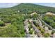 An aerial view shows a home nestled in a community surrounded by lush greenery, and a mountain in the background at 1320 Magnolia Park Cir, Cumming, GA 30040
