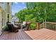 Inviting outdoor deck featuring wicker furniture, perfect for relaxing and enjoying the surrounding lush greenery at 1320 Magnolia Park Cir, Cumming, GA 30040