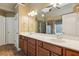 Bathroom with dual sink vanity, tile floors, and large mirror at 1320 Magnolia Park Cir, Cumming, GA 30040
