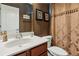 Bathroom with a white sink and toilet, along with a decorated shower curtain at 1320 Magnolia Park Cir, Cumming, GA 30040