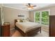 Bedroom with a ceiling fan, one window, and a wooden bed frame at 1320 Magnolia Park Cir, Cumming, GA 30040