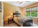 Bedroom with a ceiling fan, a window, a bed, and wall decor at 1320 Magnolia Park Cir, Cumming, GA 30040