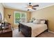 Bedroom with a ceiling fan, a window, a bed, and two side tables at 1320 Magnolia Park Cir, Cumming, GA 30040