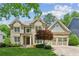 Charming two-story brick home featuring an attached two-car garage and a well-manicured front yard at 1320 Magnolia Park Cir, Cumming, GA 30040
