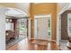 Elegant foyer featuring hardwood floors, high ceilings, and an arched doorway leading to the dining room at 1320 Magnolia Park Cir, Cumming, GA 30040