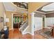 Spacious foyer with hardwood floors, stairs, and open views of the dining and living areas at 1320 Magnolia Park Cir, Cumming, GA 30040