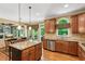 Bright eat-in kitchen features granite countertops, stainless appliances, and backyard views at 1320 Magnolia Park Cir, Cumming, GA 30040