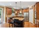 Well-equipped kitchen with wooden cabinets, granite countertops, and stainless steel appliances at 1320 Magnolia Park Cir, Cumming, GA 30040