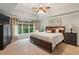 Main bedroom features a tray ceiling, large windows, and a cozy sitting area at 1320 Magnolia Park Cir, Cumming, GA 30040