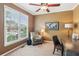 Cozy home office with a window, a chair, a desk, and neutral-toned walls and carpeting at 1320 Magnolia Park Cir, Cumming, GA 30040