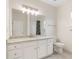 Bathroom with granite countertops, white cabinets, and modern lighting fixture at 2561 Grapevine Cir # 104, Cumming, GA 30041