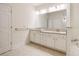 Bathroom featuring double sinks with granite countertop, tile floors, and tub at 2561 Grapevine Cir # 104, Cumming, GA 30041