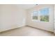 Bright bedroom featuring hardwood floors and two windows offering abundant natural light and community views at 2561 Grapevine Cir # 104, Cumming, GA 30041