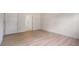 Bedroom with light wood floors, fresh paint, and open door at 2561 Grapevine Cir # 104, Cumming, GA 30041
